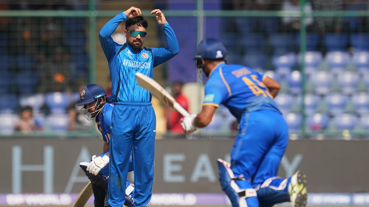 (AP Photo/Manish Swarup) : Afghanistan's captain Rashid Khan, centre, watches United Arab Emirates' Sohaib Khan after bowls a delivery during the T20 World Cup cricket match between Afghanistan and United Arab Emirates in New Delhi, India, Monday, Feb. 16, 2026. 