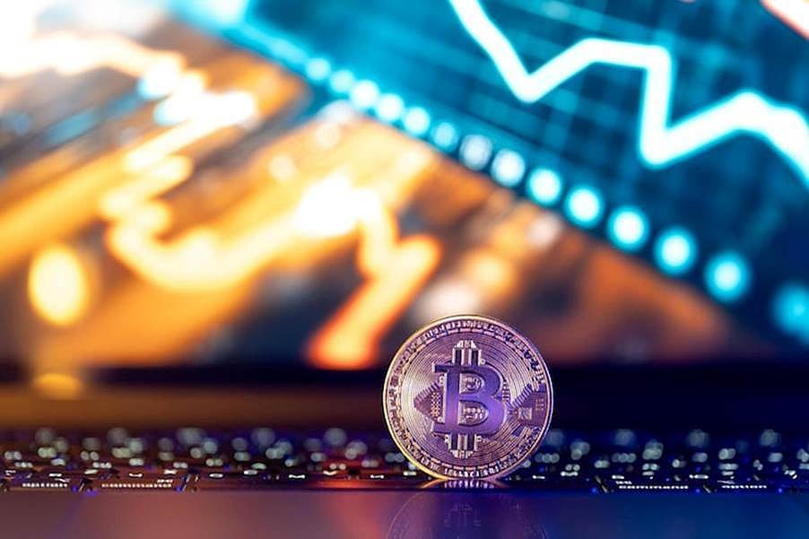 Bitcoin coin with glowing chart and bullish arrow in blue and orange lights