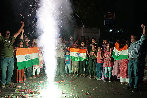 Indian fans celebrate Indian team's victory against Pakistan in ICC men's T20 World Cup cricket match played at Colombo in Sri Lanka, in Ahmedabad.