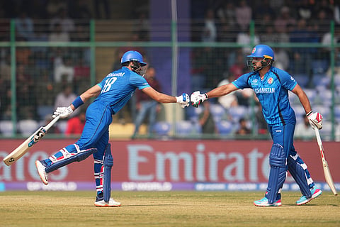 Afghanistan's Ibrahim Zardan, left, celebrates with Gulbadin Naib after hits a six during the T20 World Cup cricket match between Afghanistan and United Arab Emirates in New Delhi.