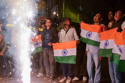 Cricket fans celebrate India's victory over Pakistan in the ICC Men's T20 World Cup 2026 cricket match, in Kanpur.