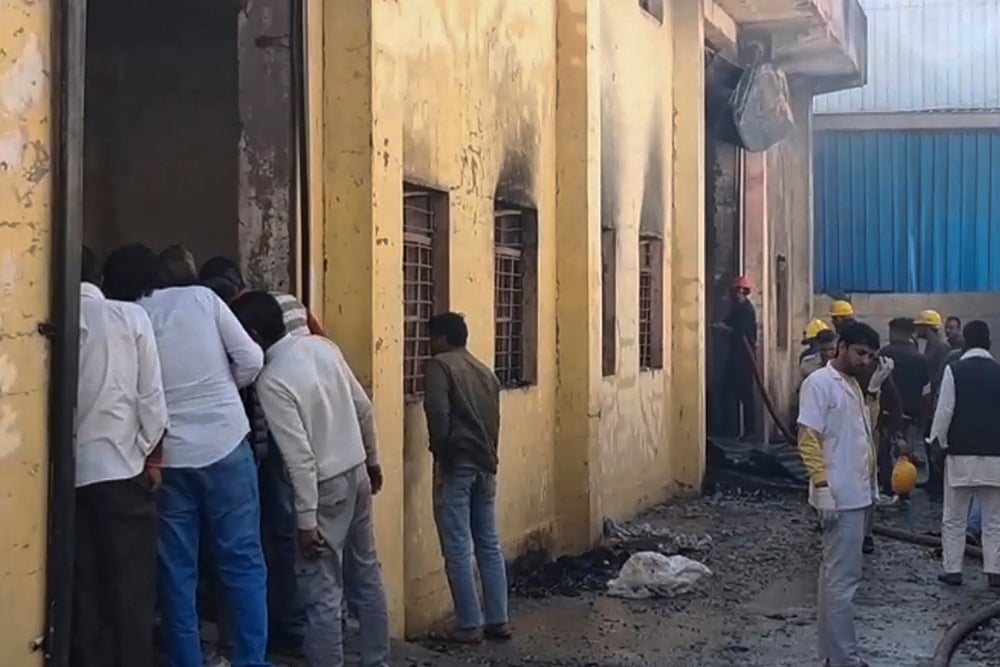 | Photo: Handout via PTI  : Firefighters and locals at a chemical factory building after a fire broke out at the premises, in the Khushkhera-Karouli Industrial Area of Bhiwadi, Rajasthan. Officials said seven workers were killed and two others were feared trapped after a fire broke out at the unit. 