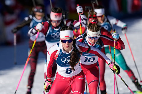 Kamila Zuk, of Poland, leads a group during the women's 10-kilometer pursuit biathlon race at the 2026 Winter Olympics in Anterselva, Italy.