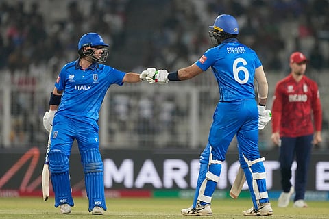 Italy's Justin Mosca, left, Grant Stewart encourage each other as they bat during the T20 World Cup cricket match between England and Italy in Kolkata, India.