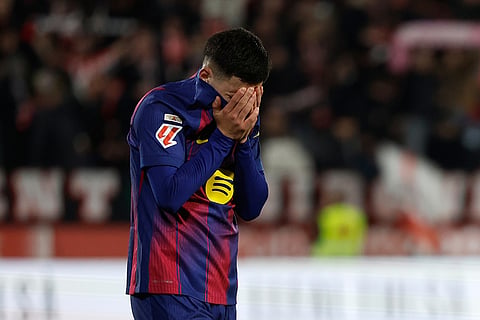 Barcelona's Roony Bardghji reacts as Girona players celebrate after winning a Spanish La Liga soccer match between Girona and Barcelona in Girona, Spain.