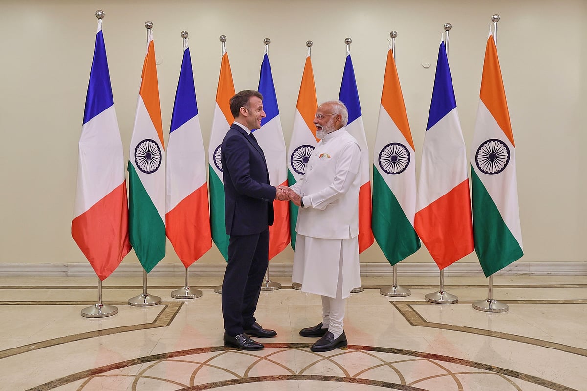 Indian Prime Minister Narendra Modi, right, welcomes French President Emmanuel Macron in Mumbai