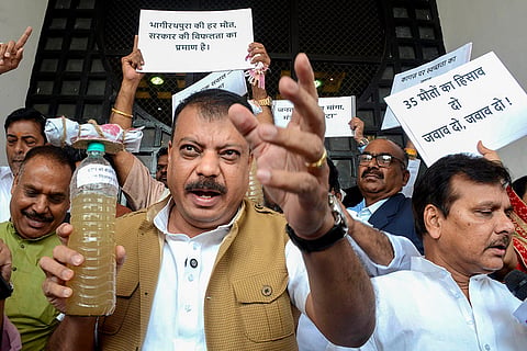 LoP in the Madhya Pradesh Assembly and Congress leader Umang Singhar with party MLAs stages a protest over Indore's water contamination deaths, during the Budget session of the state Assembly, in Bhopal.