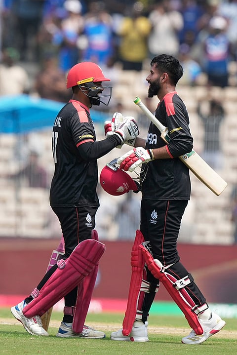 Canada's Yuvraj Samra, right, congratulated by Navneet Dhaliwal after he scores century during the T20 World Cup cricket match between Canada and New Zealand in Chennai.