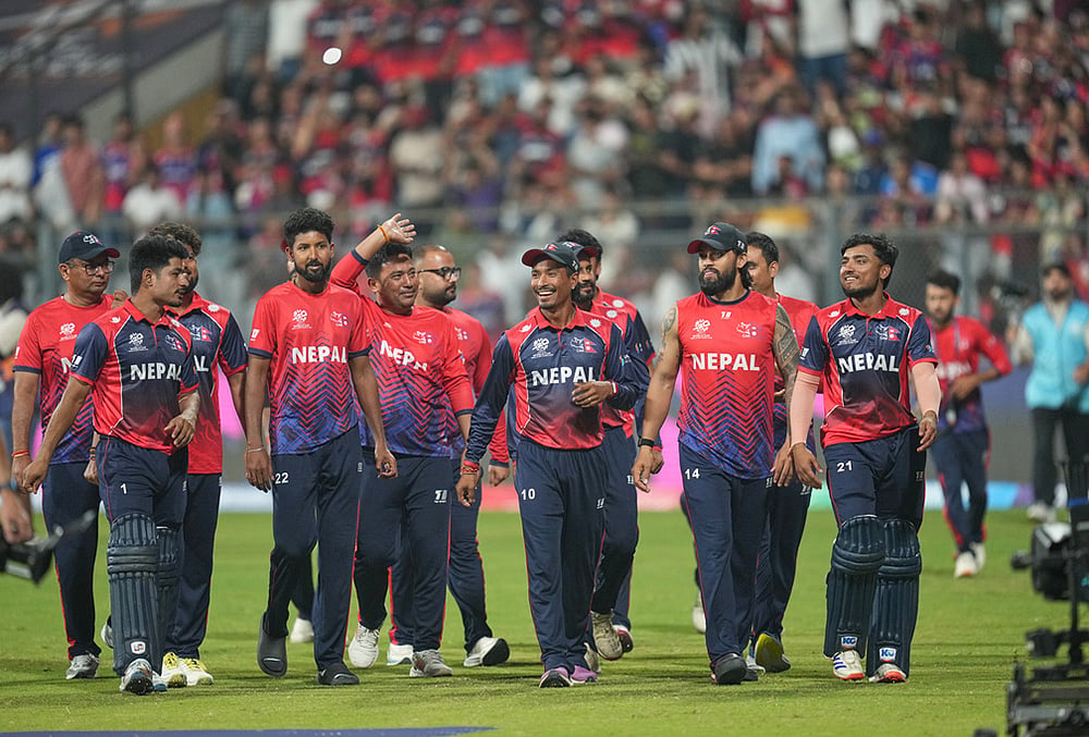 Nepal cricket team walks back to the pavilion after defeating Scotland during the T20 World Cup cricket match in Mumbai. - | Photo: AP/Rafiq Maqbool