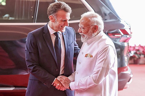 In this image posted on Feb. 17, 2026, Prime Minister Narendra Modi welcomes French President Emmanuel Macron during the latter's visit to Mumbai.