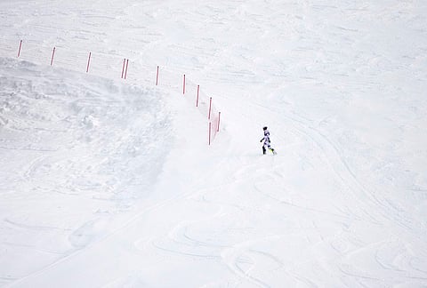 Norway's Atle Lie McGrath walks off the course after skiing out during an alpine ski, men's slalom race, at the 2026 Winter Olympics, in Bormio, Italy.
