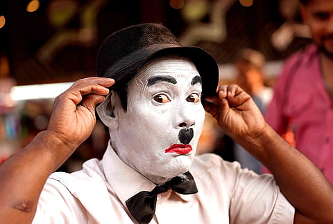 Before stepping into the bustling lanes of Dadar, Afsar Khan carefully applies his makeup, transforming into Charlie Chaplin for another day of performance in Mumbai.