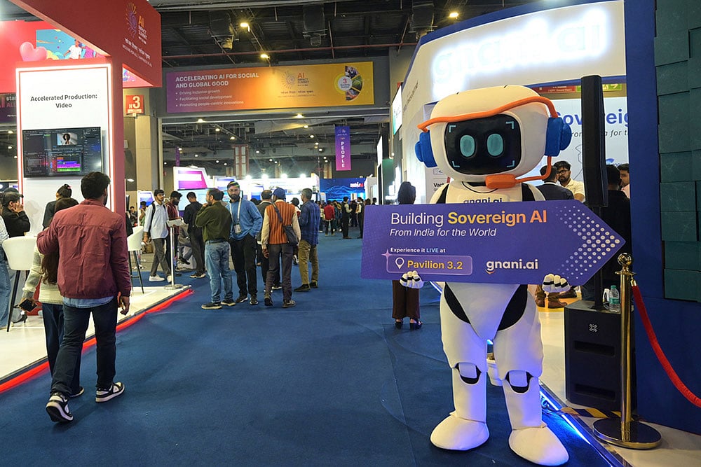 | Photo: AP : Delegates watch an exhibition in the sidelines of an AI Impact Summit in New Delhi.