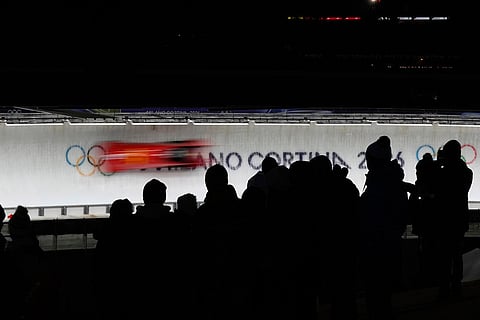 China's Kaizhi Sun and Tai An slide down the track during a two man bobsled run at the 2026 Winter Olympics, in Cortina d'Ampezzo, Italy.