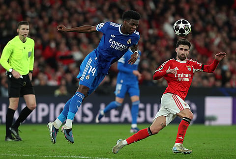 Real Madrid's Aurelien Tchouameni fights for the ball against Benfica's Rafa Silva during a Champions League playoff soccer match between SL Benfica and Real Madrid in Lisbon, Portugal.