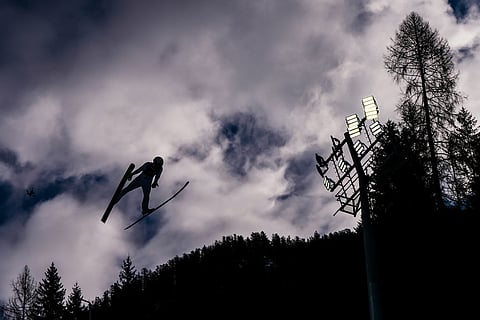 Ryota Yamamoto, of Japan, soars through the air during his competition round jump of the nordic combined individual Gundersen large hill/10km at the 2026 Winter Olympics, in Predazzo, Italy.