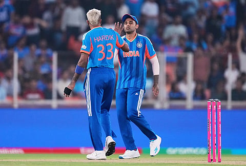 India's Hardik Pandya, left, celebrates with captain Suryakumar Yadav the wicket of Netherlands' Michael Levitt during the T20 World Cup cricket match between India and Netherlands in Ahmedabad.