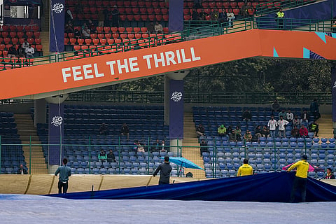 Groundsmen remove covers from the field before the start of the ICC Men's T20 World Cup 2026 cricket match between South Africa and UAE, at Arun Jaitley Stadium, in New Delhi.