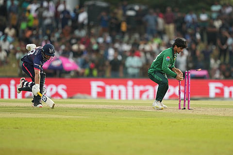 Pakistan's Saim Ayub, right, breaks the stumps to runout Namibia's Nicol Loftie-Eaton, left, during the T20 World Cup cricket match between Namibia and Pakistan in Colombo, Sri Lanka.