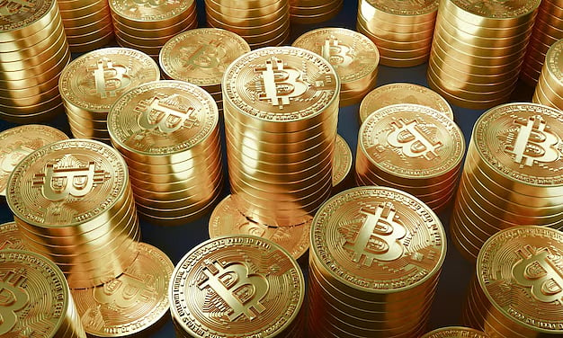 Stacks of gold Bitcoin coins on a dark background