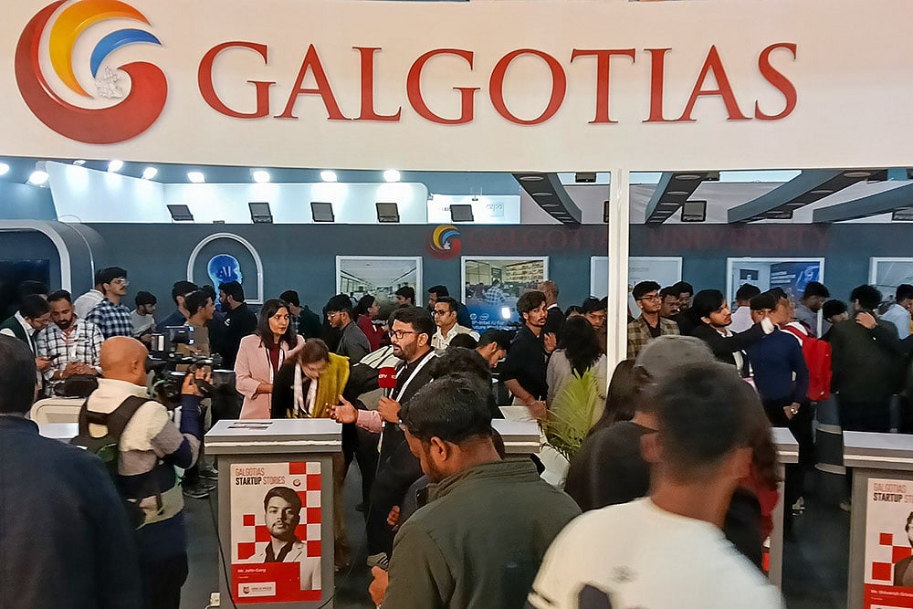 | Photo: PTI : Visitors at Galgotias University's stall during the India AI Impact Summit 2026, in New Delhi. The University has been asked to vacate its stall at the AI Summit Expo immediately, sources said on Wednesday, amid a controversy over the display of a robotic dog that raised questions about the origin and ownership of the technology showcased.
