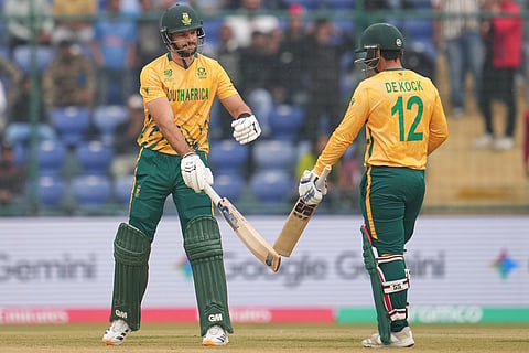 South Africa's captain Aiden Markram and Quinton de Kock celebrate after hits a six during the T20 World Cup cricket match between South Africa and United Arab Emirates in New Delhi.