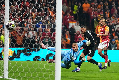 Galatasaray's Sacha Boey, right, scores his side's fifth goal during a Champions league play-off first leg soccer match between Galatasaray and Juventus, in Istanbul, Turkey.