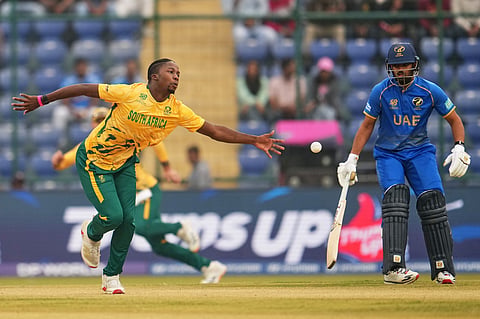 South Africa's Kwena Maphaka fields the ball as United Arab Emirates' Aryansh Sharma looks on during the T20 World Cup cricket match between South Africa and United Arab Emirates in New Delhi.