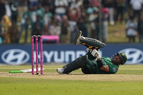 Pakistan's Sahibzada Farhan falls on ground after a muscle cramp during the T20 World Cup cricket match between Namibia and Pakistan in Colombo, Sri Lanka.