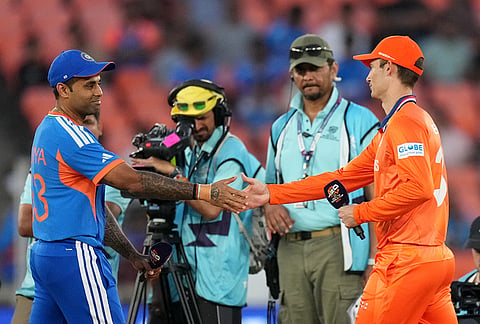 India's captain Suryakumar Yadav, left, and Netherlands' captain Scott Edwards shake hands after the coin toss of the T20 World Cup cricket match between India and Netherlands in Ahmedabad.