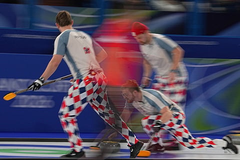 Norway's Martin Sesaker, Bendik Ramsfjell, Gaute Nepstad in action during the men's curling round robin session against Sweden at the 2026 Winter Olympics, in Cortina d'Ampezzo, Italy/