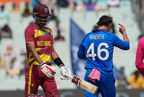 Italy's Benjamin Manenti, right, celebrates the wicket of West Indies' Roston Chase, left, during the T20 World Cup cricket match between West Indies and Italy in Kolkata.