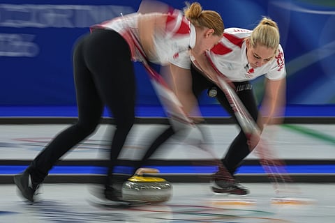 Denmark's Denise Dupont and Mathilde Halse in action during the women's curling round robin session against Switzerland at the 2026 Winter Olympics, in Cortina d'Ampezzo, Italy.