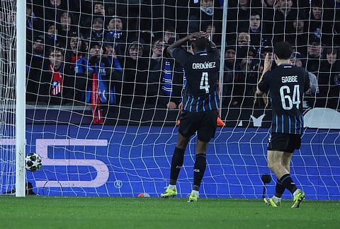 Brugge's Joel Ordonez, centre, reacts after scoring the own goal during the Champions League play-off first leg soccer match between Club Brugge and Atletico Madrid, in Bruges, Belgium.