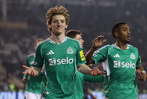 Newcastle's Anthony Gordon, left, celebrates after scoring his side's first goal during the Champions League play-off first leg soccer match between Qarabag and Newcastle in Baku, Azerbaijan.