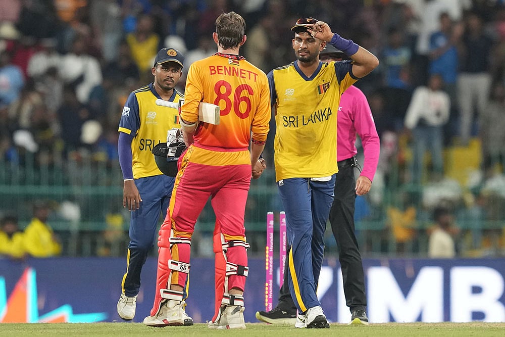 | Photo: AP/Eranga Jayawardena : Sri Lanka's captain Dasun Shanaka, right, congratulate Zimbabwe's Brian Bennett after Zimbabwe won the T20 World Cup cricket match in Colombo, Sri Lanka.