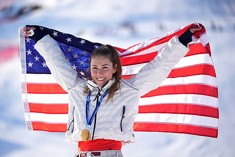 United States' Mikaela Shiffrin celebrates winning the gold medal in an alpine ski, women's slalom race, at the 2026 Winter Olympics, in Cortina d'Ampezzo, Italy.