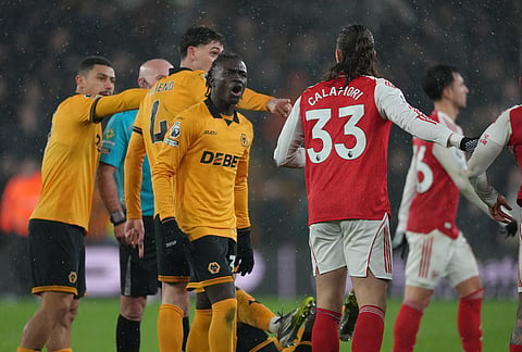 Wolverhampton Wanderers' Mateus Mane, argues with Arsenal's Riccardo Calafiori during the Premier League soccer match between Wolverhampton Wanderers and Arsenal in Wolverhampton, England.