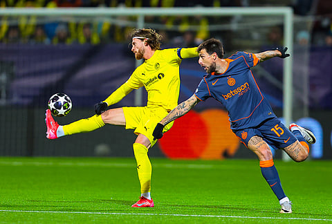 Bodø/Glimt's Kasper Høgh, left, Inter Milan's Francesco Acerbi vie for the ball during a Champions League soccer match in Bodo, Norway.