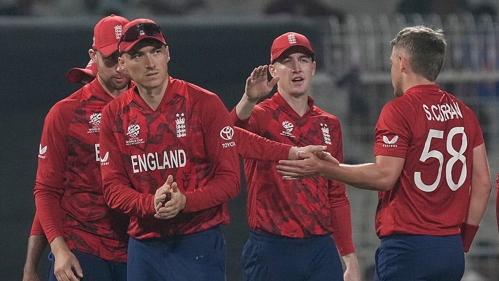 Photo: AP/Bikas Das : England's Sam Curran, right, celebrates with teammates the wicket of Italy's Marcus Campopiano during the T20 World Cup cricket match between England and Italy in Kolkata, India.