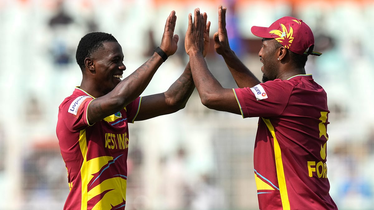 (AP Photo/Bikas Das) : West Indies' Shamar Joseph, left, and West Indies' Matthew Forde celebrates the wicket of Italy's Thomas Draca during the T20 World Cup cricket match between West Indies and Italy in Kolkata, India, Thursday, Feb. 19, 2026. 
