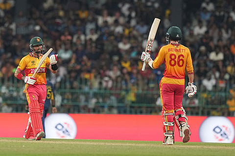 Zimbabwe's Brian Bennett, right, celebrates his fifty runs during the T20 World Cup cricket match between Sri Lanka and Zimbabwe in Colombo, Sri Lanka.