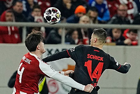 Leverkusen's Patrik Schick, right, and Olympiacos' Giulian Biancone fight for the ball during a Champions League playoff soccer match between Olympiacos and Bayer 04 Leverkusen in Piraeus port, near Athens.