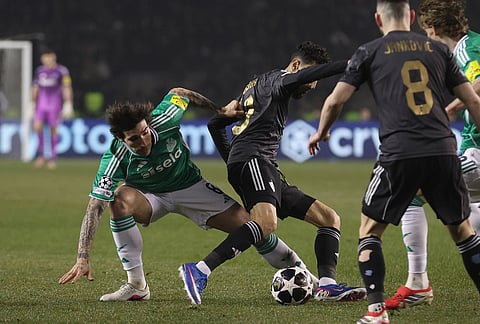 Newcastle's Sandro Tonali, left, fights for the ball with Qarabag's Abdellah Zoubir during the Champions League play-off first leg soccer match between Qarabag and Newcastle in Baku, Azerbaijan.