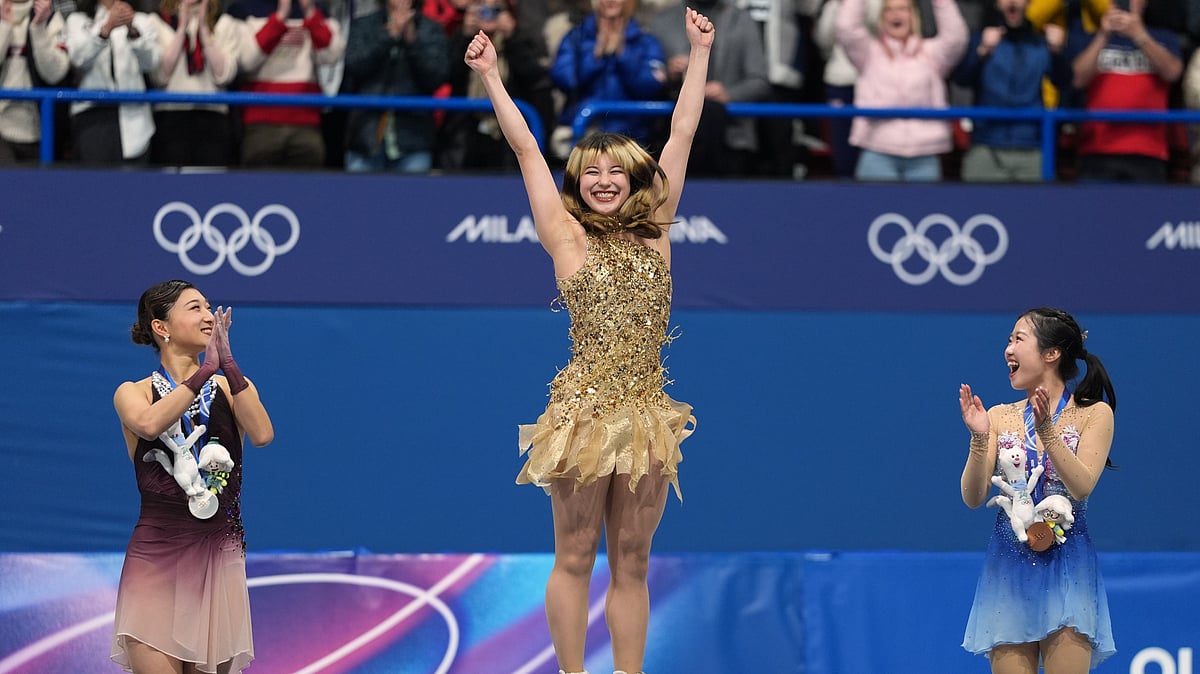 (AP Photo/Stephanie Scarbrough) : From left to right, silver medalist Kaori Sakamoto of Japan, gold medalist Alysa Liu of the United States, and bronze medalist Ami Nakai of Japan, jump on the podium to receive their medals after competing in the women's free skate program in figure skating at the 2026 Winter Olympics, in Milan, Italy, Thursday, Feb. 19, 2026.