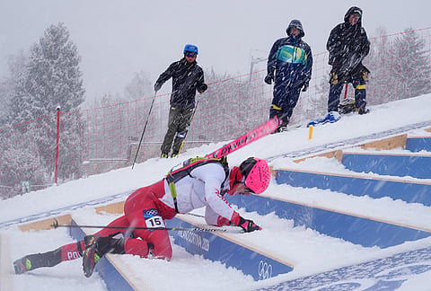 Poland's Jan Elantkowski falls as he competes during a ski mountaineering men's sprint heat, at the 2026 Winter Olympics, in Bormio, Italy.