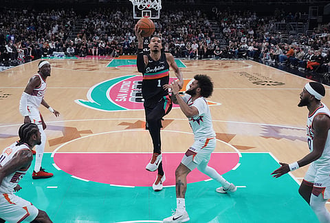 San Antonio Spurs forward Victor Wembanyama (1) shoots the ball past Phoenix Suns forward Isaiah Livers (18) during the first half of an NBA basketball game in Austin, Texas.