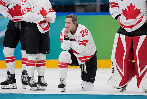 Canada's Marie-Philip Poulin (29) waits for the medal ceremony after a women's ice hockey gold medal game between the United States and Canada at the 2026 Winter Olympics, in Milan, Italy.