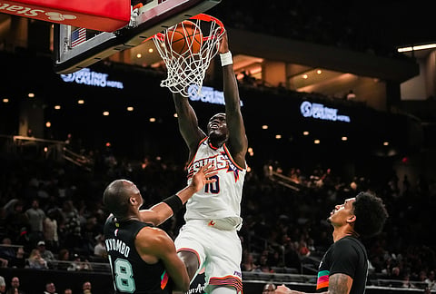 Phoenix Suns center Khaman Maluach (10) dunks over San Antonio Spurs center Bismack Biyombo (18) in the fourth quarter of an NBA basketball game in Austin, Texas.