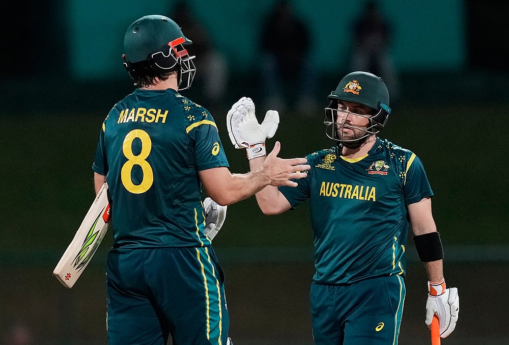 | Photo: AP/Eranga Jayawardena : Australia's captain Mitchell Marsh and Australia's Adam Zampa celebrate after winning the T20 World Cup cricket match between Australia and Oman in Pallekele, Sri Lanka.
